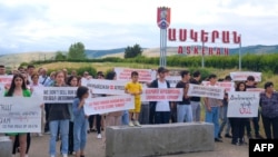 Activists block a road from Stepanakert, the capital of the Nagorno-Karabakh enclave, to Azerbaijani Aghdan to decry conditions in the region in Askeran on July 18.