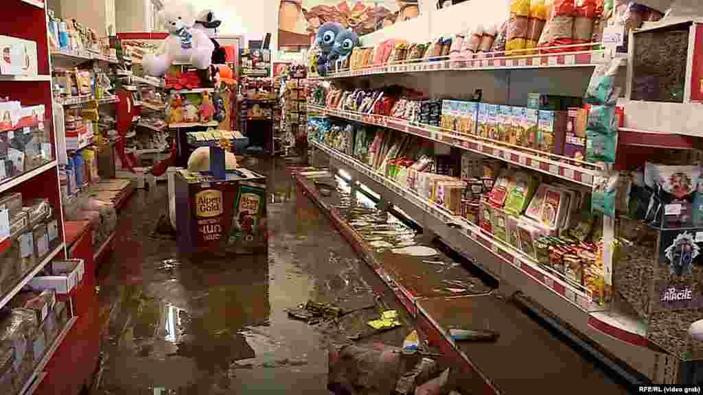 Another video grab shows the flooding in a grocery store. Many of the town&#39;s shops and homes suffered damage.