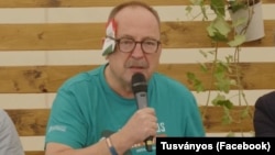 Hungarian Fidesz lawmaker Zsolt Nemeth with a folded paper "bandage" over his ear at the Tusvanyos Festival in eastern Transylvania on July 24.