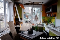 The same kitchen as in the previous photo, photographed in March 2023 after nearby explosions blew out the windows.