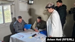 Sladjana Pantovic, a candidate for mayor of Zvecan, casts her vote in Kosovo on April 23 accompanied by a security escort.