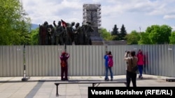 Хора са се събрали около оградата на съветския паметник в деня, в който плочите на постамента бяха премахнати. 22 април 2024 г.