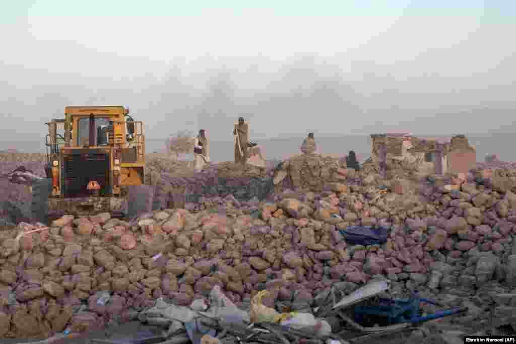 Afghan men search for victims.