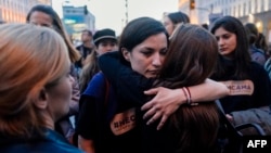 Women hug each other during a march for gender equality and against violence toward women, on International Women's Day, in Sofia, on March 8, 2019.