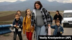 Ethnic Armenians from Nagorno-Karabakh walk flee the region following Azerbaijan's swift military operation to retake the breakaway territory.