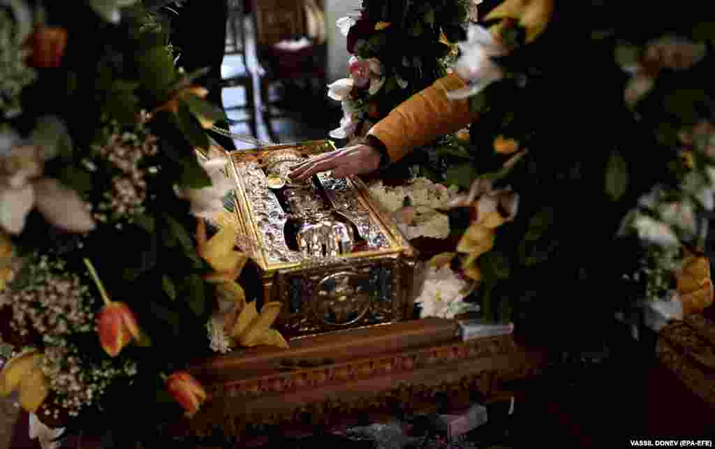 An Orthodox believer touches the relics of St. George the Great Martyr on display at the church of St. Sofia in Sofia. A fragment of the right hand of St. George, which is kept in the Church of St. George the Victorious in Nigrita, Greece, arrived in Sofia ahead of the celebration of the church holiday of St. George in Bulgaria on May 6.