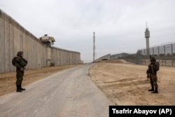 Soldații israelieni păzesc bariera de securitate fortificată de-a lungul graniței dintre Israel și Gaza la scurt timp după finalizarea acesteia în 2021.
