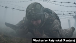 Një rekrut i ri në ushtrinë ukrainase duke marrë pjesë në stërvitje ushtarake në një vend të panjohur në Ukrainën qendrore, 12 mars 2024.