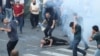 Armenia - A protester is injured by a stun grenade thrown by riot police, Yerevan, June 12, 2024.