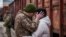 UKRAINE -- Ukrainian serviceman says goodbye to his wife who was visiting him during a short break from his frontline duty