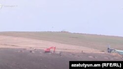 Armenia - Azerbaijani troops dig trenches outside Tegh village.