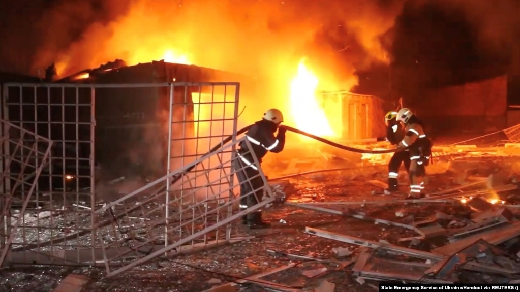 Emergency personnel work to put out a fire following a drone attack in Kharkiv in a video released on January 31.