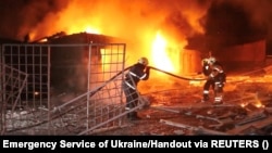 Emergency personnel work to put out a fire following a drone attack in Kharkiv in a video released on January 31.