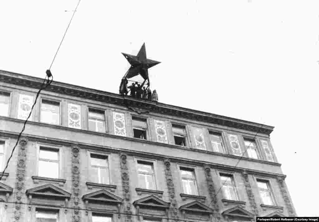 Amid a ruthlessly violent uprising against communist rule in Hungary in 1956, the red star became a target for ascendant revolutionaries. This image shows a star being wrenched off a building in central Budapest.&nbsp;
