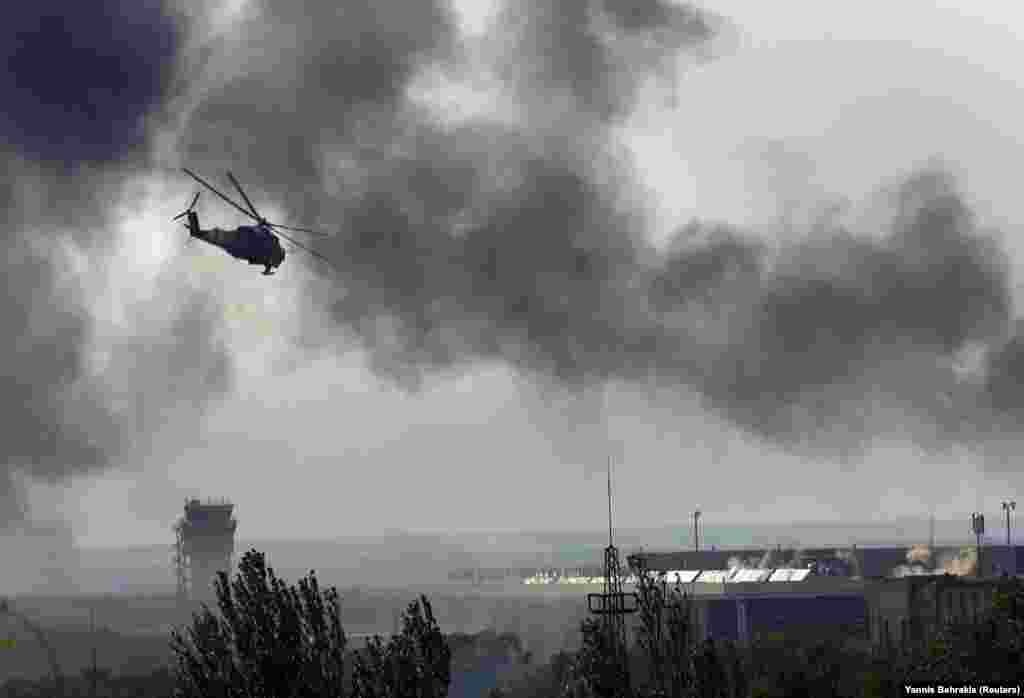 A Ukrainian helicopter gunship fires its autocannon at the separatist-held airport on May 26. By May 27, 2014, the airport had been recaptured by Ukrainian forces, who would hold it for several months as war with Russian-backed separatists spread across the eastern Donbas region.