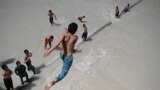 AFGHANISTAN -- A man plunges into a river in Kishindeh district of Balkh province, JUNE 4, 2023
