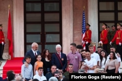 Former U.S. President Bill Clinton (center) and Albanian Prime Minister Edi Rama (left) pose for a picture with people who were named after Clinton in gratitude for his role in stopping the 1998-99 Kosovo War, in Tirana on July 3, 2023.