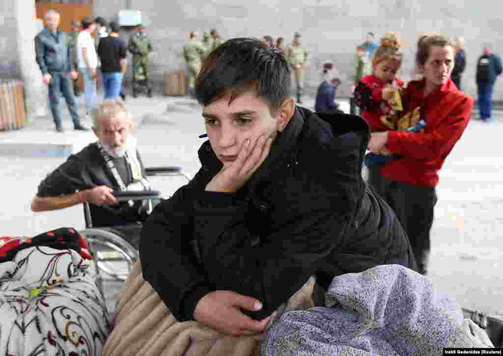 A refugee boy from the Nagorno-Karabakh region waits upon his arrival at a temporary accommodation center in the town of Goris, Armenia, on September 25.