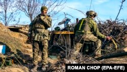 Soldații ucraineni stau pe poziții dintr-o unitate antiaeriană într-o locație nedezvăluită în apropierea orașului Bahmut. Fotografie făcută pe 25 martie 2023.