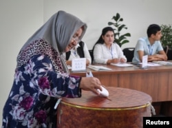 Женщина голосует на досрочных президентских выборах в Ташкенте, Узбекистан, 9 июля 2023 года