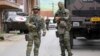 German KFOR soldiers guard the municipal building following clashes between ethnic Serbs and troops from the NATO-led KFOR peacekeeping force in Zvecan, northern Kosovo, on May 30.