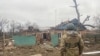 A Ukrainian soldier surveys the ruins of a house hit by recent shelling in the Donetsk region on December 23.