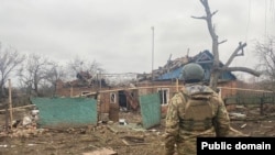 A Ukrainian soldier surveys the ruins of a house hit by recent shelling in the Donetsk region on December 23.