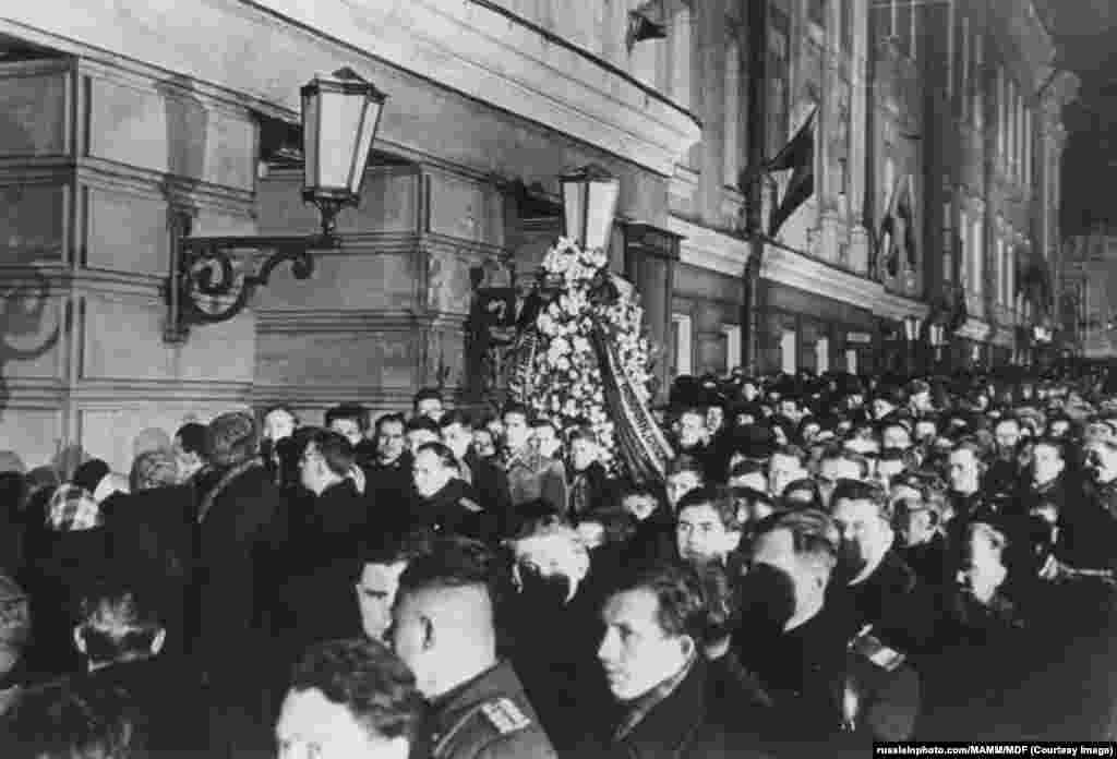 Evening crowds gather to pay their respects to Stalin as he lay in state in the House of the Unions on March 6. Several mourners died in a crush outside the building as crowds gathered to view Stalin&#39;s remains. A witness describes crowds shouting to remove trucks that people were being smothered against as one desperate policeman shouted that he had &quot;no instructions&quot; to move one of the vehicles that he was sitting inside.