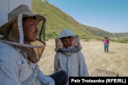 Beekeeper Tynychtyk Satarov (left) with his son Ulykbek in the Naryn region of Kyrgyzstan in early August.