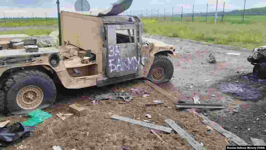 A damaged vehicle with &quot;For Bakhmut&quot; spray-painted on its door is seen in a video grab from footage believed to have been taken inside Russia on May 23.&nbsp; The raid into Belgorod was reportedly launched by the Russian Volunteer Corps and the Free Russia Legion. Both groups are made up of ethnic Russians who have fought alongside the Ukrainian military against the Russian invasion.