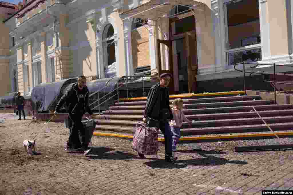 People run for cover near the train station in Kherson during an early morning Russian strike on May 3.&nbsp;Local officials said one person was killed at the train station and several others were seriously injured during the morning attack.