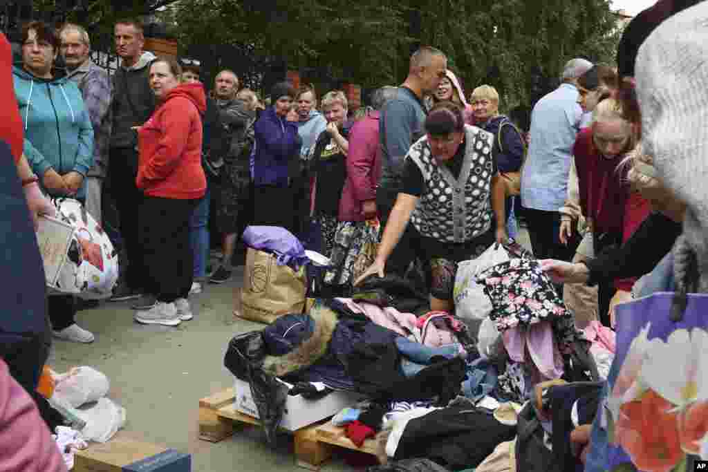 Russians evacuated from fighting during a Ukrainian incursion into Russia line up to receive humanitarian aid at a distribution center in Kursk on August 12.