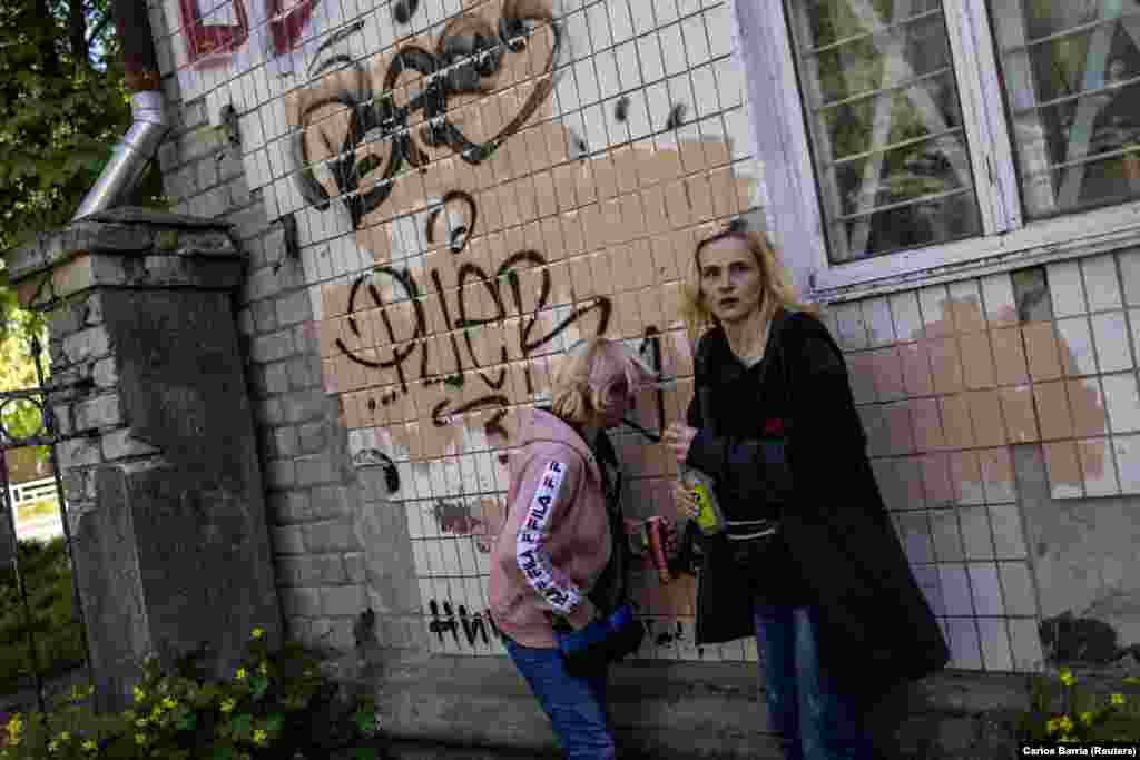 Civilians look for cover during the attack near the train station. Reuters reported that there were at least three explosions.