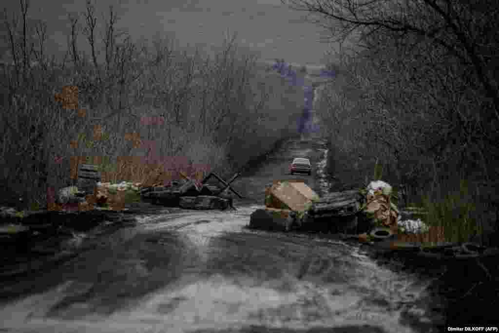 A car drives on a muddy road in Ukraine&#39;s eastern Donetsk region.