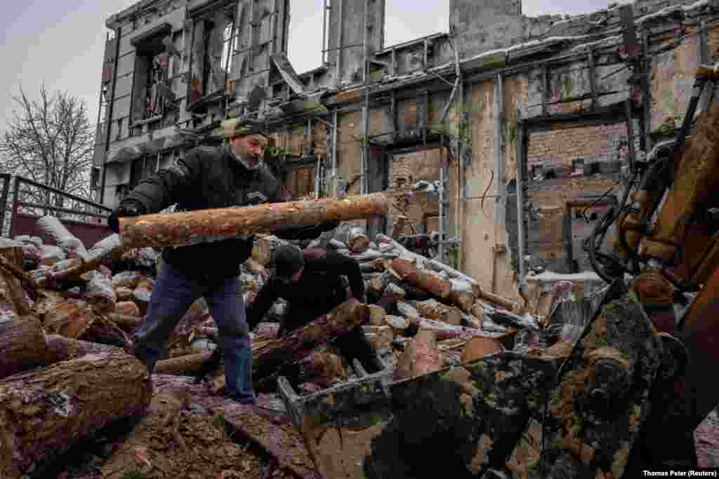 Men gather wood for homes that lost heating due to fighting in Lyman, a city in Ukraine&#39;s Donetsk region that was liberated over a year ago. Over 90 percent of the town&#39;s infrastructure has been destroyed, making life for its inhabitants increasingly difficult as temperatures drop. &nbsp;