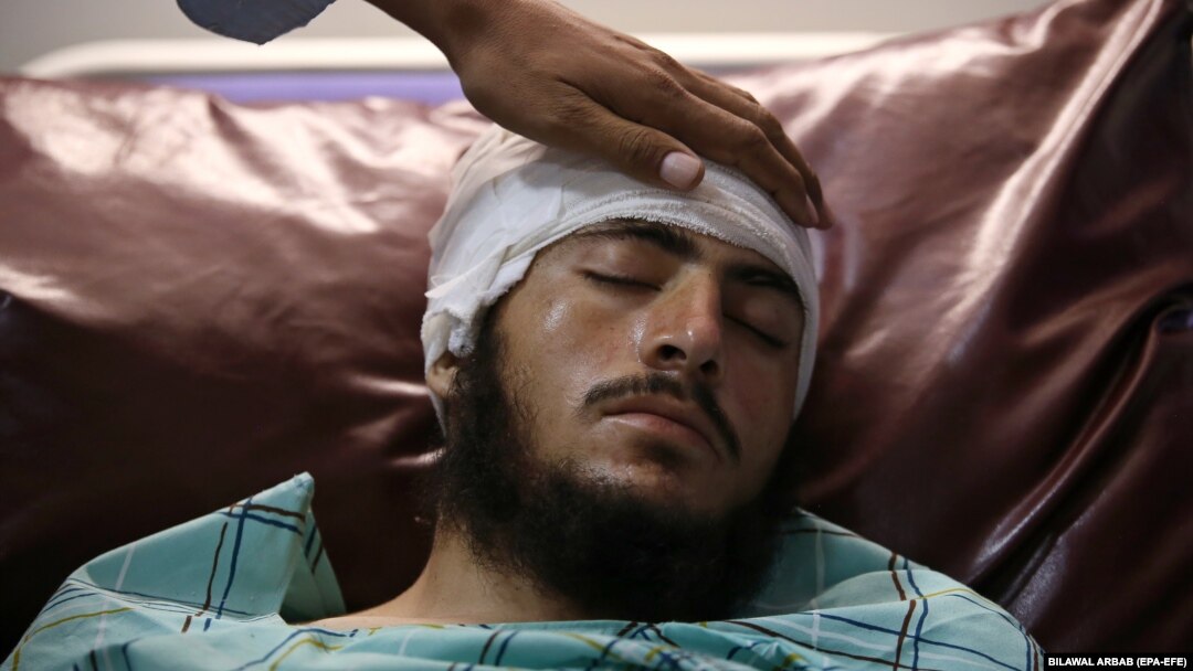 An injured man receives medical treatment at a hospital in Peshawar on July 31.
