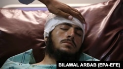 An injured man receives medical treatment at a hospital in Peshawar on July 31.