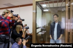 Gershkovich stands inside a defendants' cage before a court hearing to consider an appeal against his pretrial detention on espionage charges in Moscow on October 10, 2023.