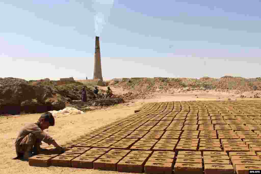 Bismillah, a 6-year-old Afghan boy, works at a brick kiln to support his family in Kandahar, earning around $2 a day, as the world marks the World Day Against Child Labor on June 12.