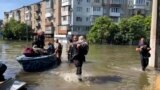 Civilians arrive in the flooded streets of Kherson on June 7th