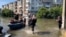 Civilians arrive in the flooded streets of Kherson on June 7th