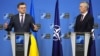 Ukrainian Foreign Minister Dmytro Kuleba (left, speaking to the press with NATO Secretary-General Jens Stoltenberg at NATO headquarters in Brussels in February) said decisions made at the summit had been "sharpened to accelerate our membership in NATO."