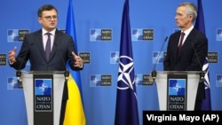 Ukrainian Foreign Minister Dmytro Kuleba (left, speaking to the press with NATO Secretary-General Jens Stoltenberg at NATO headquarters in Brussels in February) said decisions made at the summit had been "sharpened to accelerate our membership in NATO."