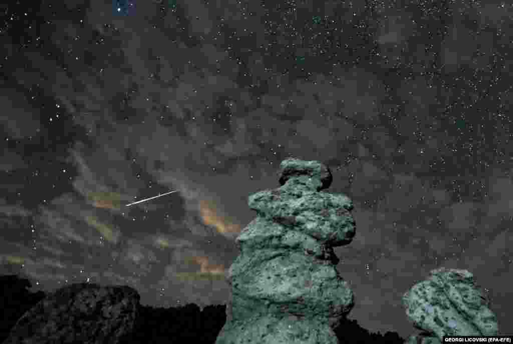 A long-exposure photo shows meteor streaks crossing the night sky over the stone dolls in Kuklica, North Macedonia.