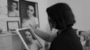 Milihate Cokli looks at a portrait of her daughter, Erona, who was murdered in April by her ex-husband.