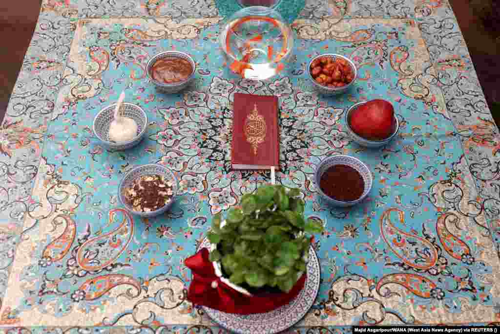 A table with an arrangement of seven symbolic items, known as haft-sin, is displayed in the house of an Iranian family in Tehran.