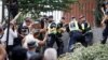 Police officers intervene following the burning of a Koran outside Stockholm's central mosque on June 28.