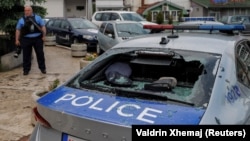 A damaged police car is seen following clashes between Kosovar police and ethnic Serb protesters in the town of Zvecan on May 26.