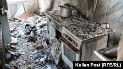 In an apartment building in the center of Luch, a kitchen remains under the rubble from a bombed-out roof.
