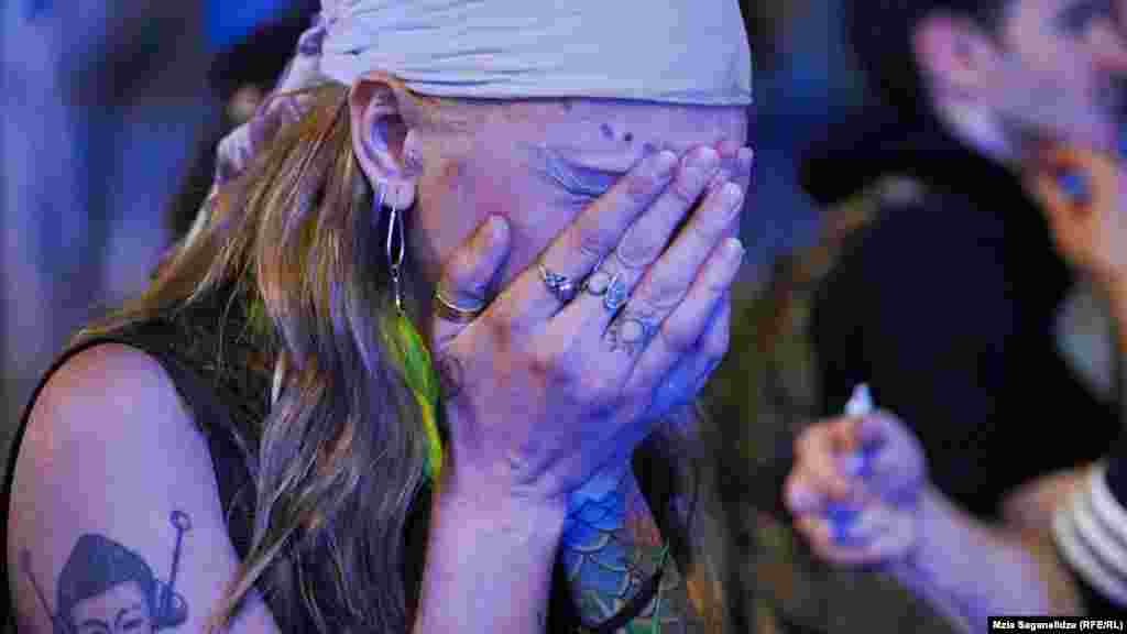 A protester reacts as water cannons and tear gas are sprayed into the crowd.